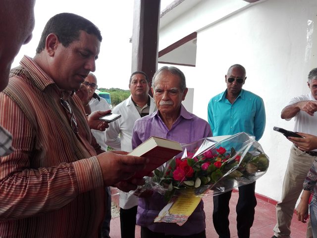 En nombre del pueblo de Manzanillo, Calixto Santiesteban Ávila y José Enrique Remón Domínguez, principales autoridades del territorio entregaron a Oscar López Rivera un ejemplar del libro El camino de la desobediencia // Foto Marlene Herrera