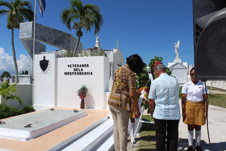 Noemí Rabaza y Daniel Rodríguez colocan una ofrenda floral en la tumba que guarda los restos de Modesto Tirado // Foto Marlene Herrrea