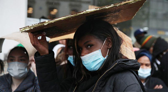 Manifestantes usando máscaras protectoras con pancartas durante una protesta de Black Lives Matter en Luton, Gran Bretaña, el 6 de junio de 2020. Foto: Reuters.