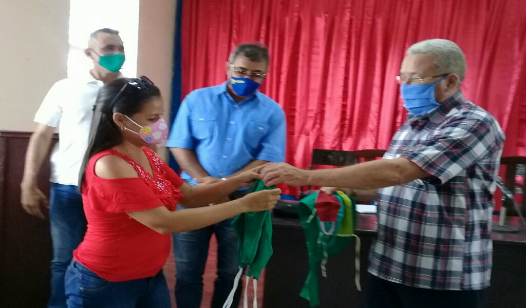 La secretaria de la FMC realiza la donación de los artículos de protección confeccionados por las federadas manzanilleras para los centros de aislamientos del territorio //Foto Eliexer Pelaez Pacheco