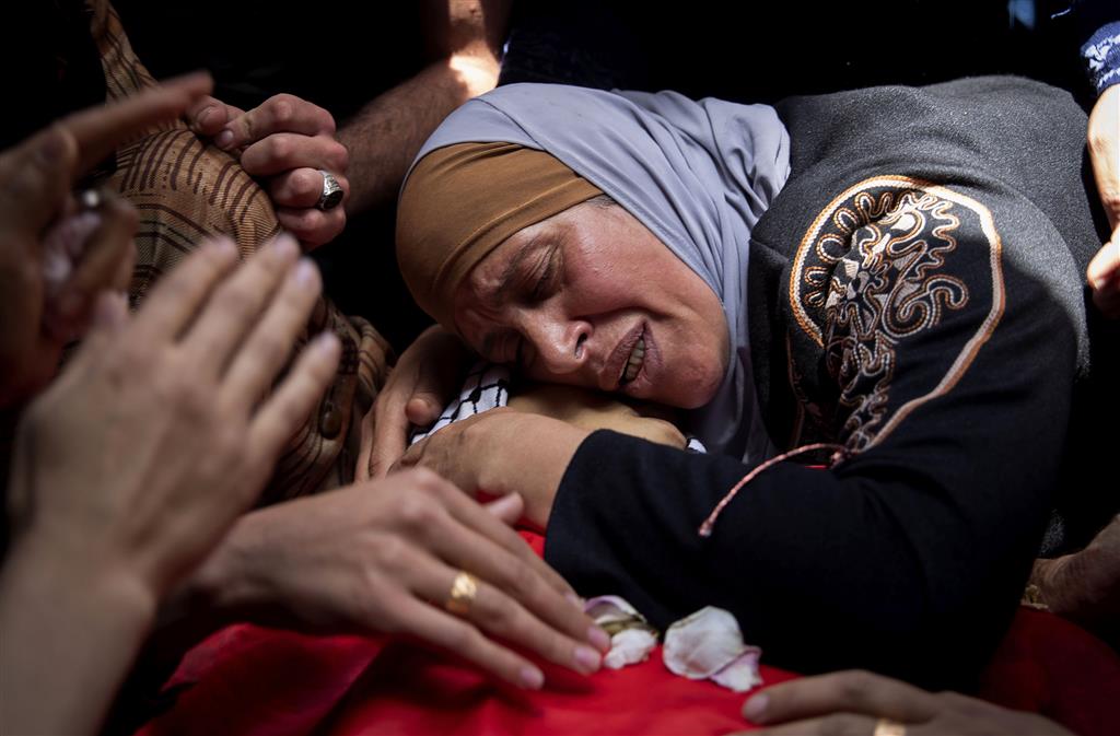 A Palestinian woman mourns over her son Rasheed Abu Arra, who was killed in clashes with Israeli forces, during his funeral in the Village of Aqqaba near the West Bank town of Tubas, Wednesday, May 12, 2021. (AP Photo / Majdi Mohammed)