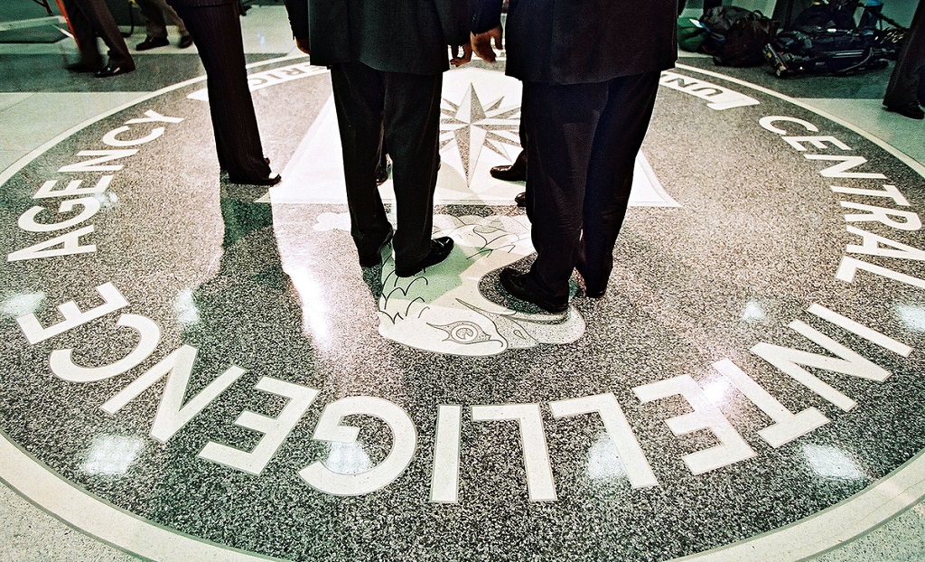386984 06: President George W. Bush, Central Intelligence Agency Director George Tenet and others stand on the seal of the Agency March 20, 2001 at the CIA Headquarters in Langley, Virginia. Bush toured the facility and met some of the Agency»s employees. (Pool Photo by David Burnett/Newsmakers)